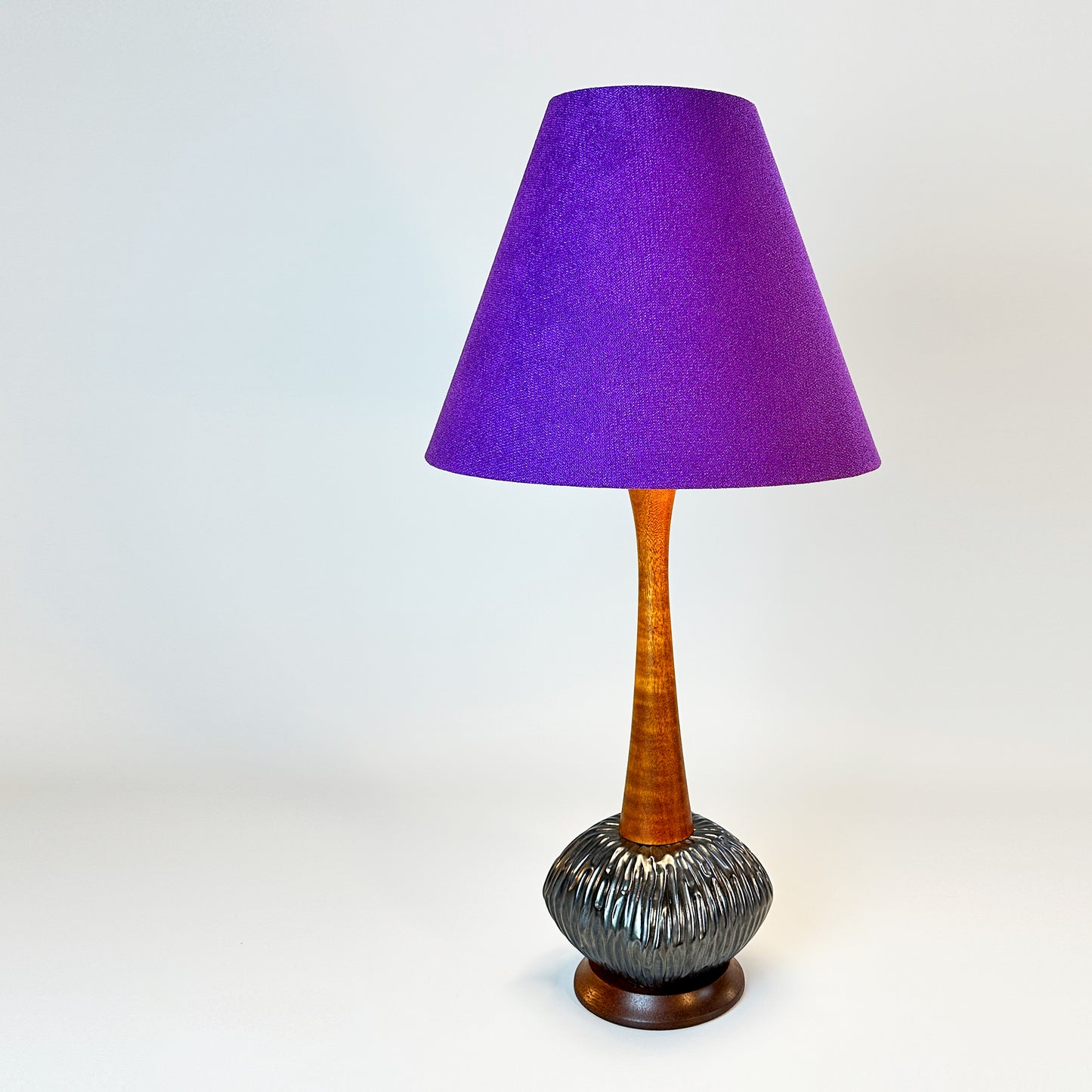 A sleek vintage mid-century modern tall table lamp + handmade lampshade crafted from luxurious purple textured recycled fabric.