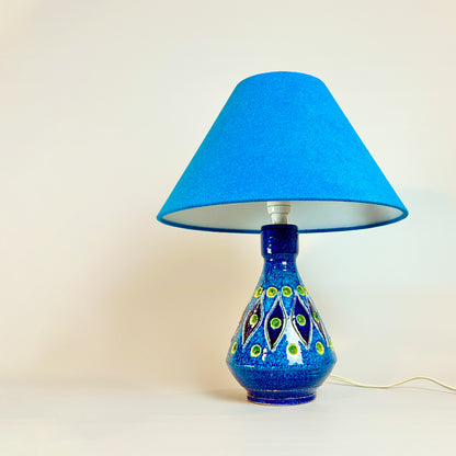 Rimini Blue Gem  Discover the allure of a Rare Mid Century Italian Ceramic Lamp Base, boasting an enchanting Rimini blue and yellow glaze. This vintage gem, bathed in the elegance of a bygone era with maker marked “Italy”.   Complemented by a bespoke handmade empire lampshade. Crafted with recycled lampshade rings and Turquoise fabric made from 40% recycled polyester